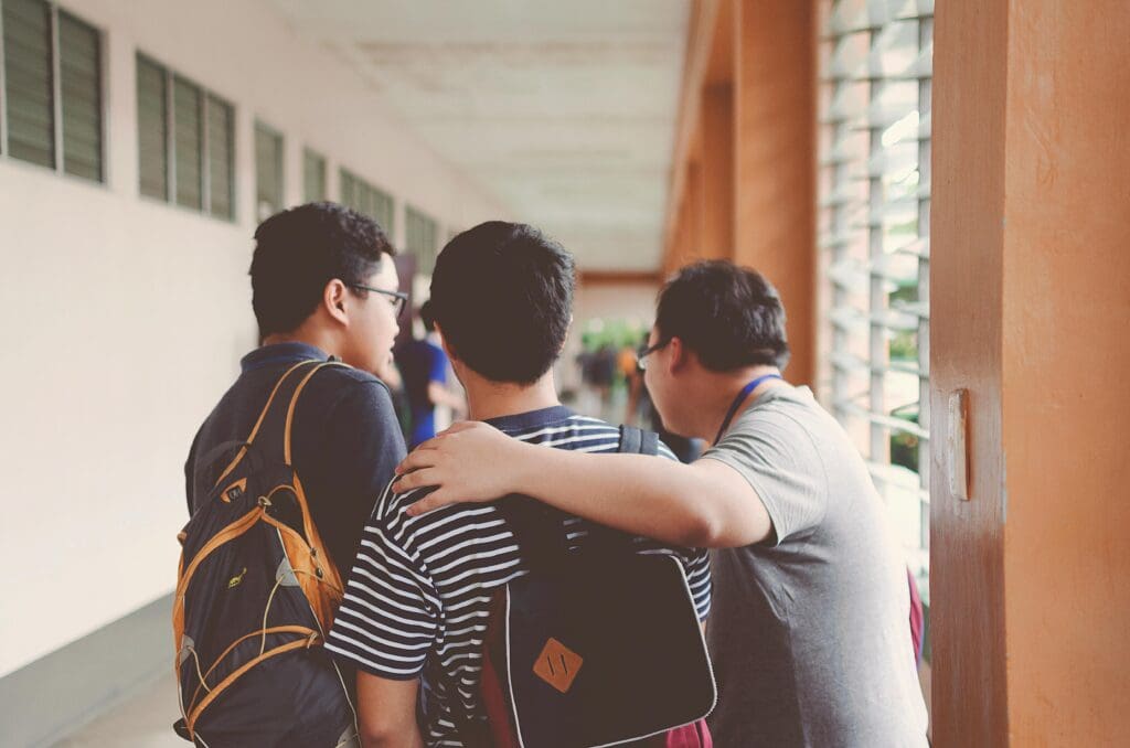 School children and a teacher join in the hallway of a school